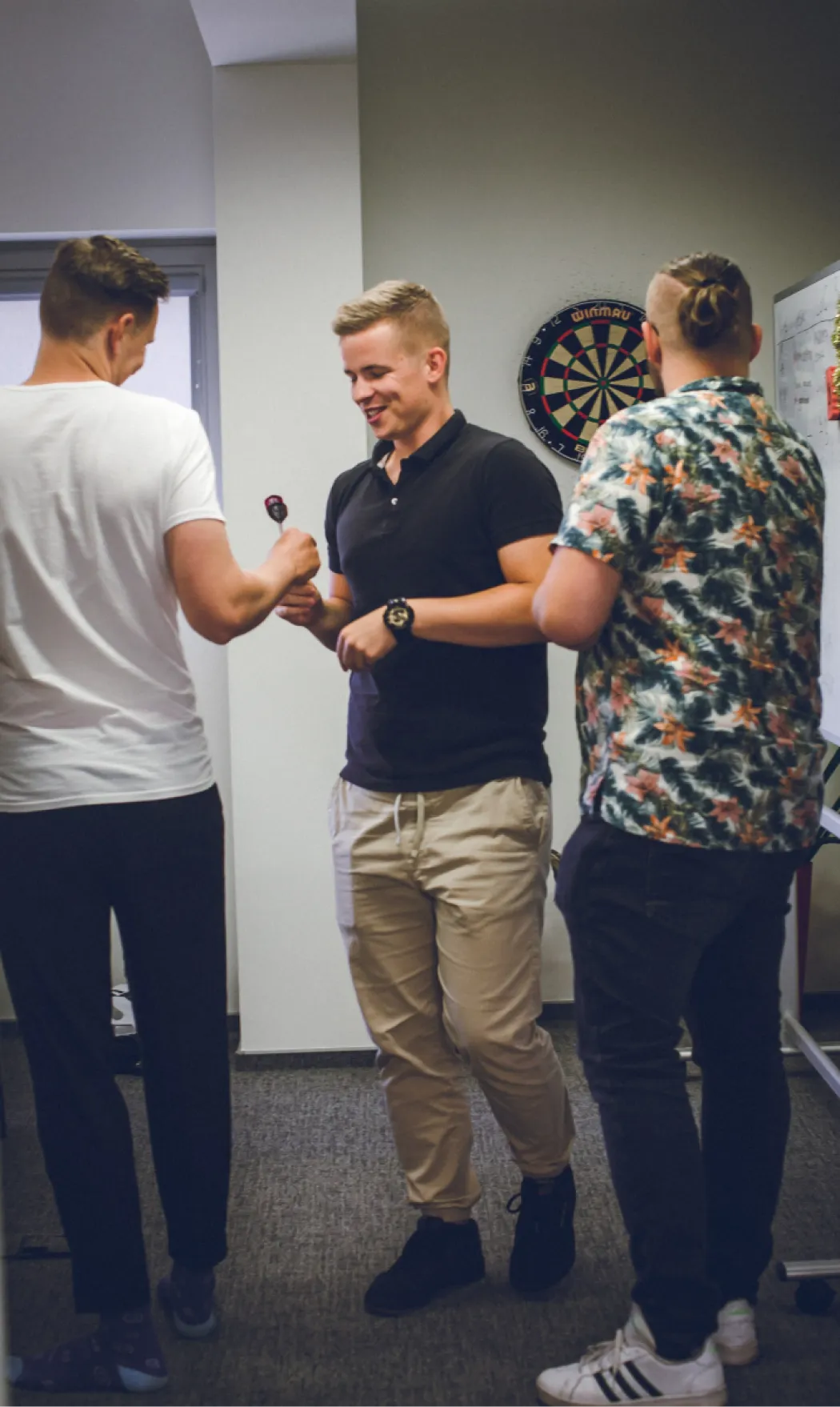 a group of people playing darts