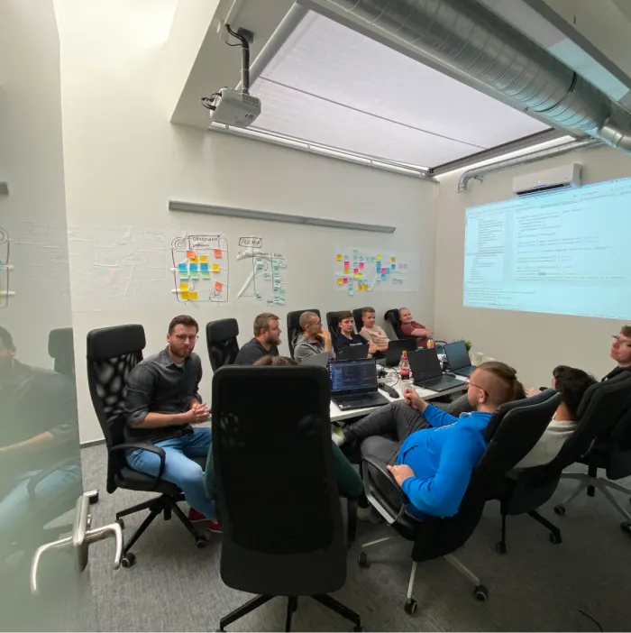 a group of programmers talking at a table