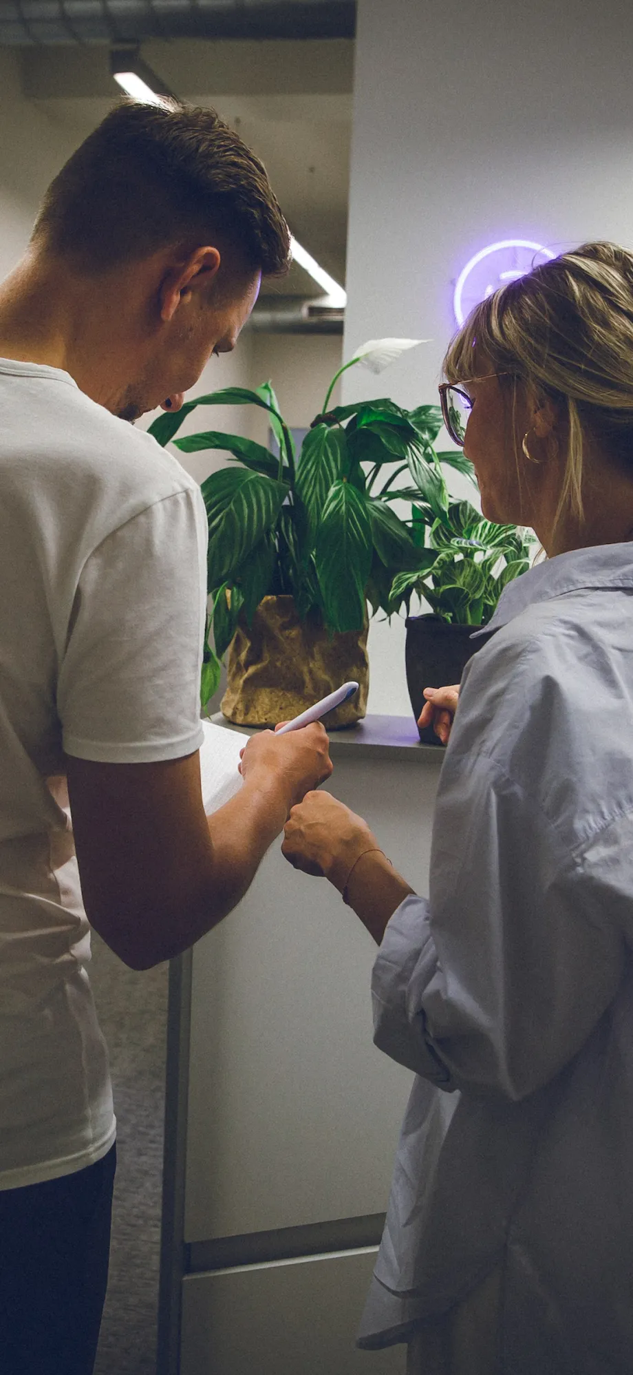 man and woman tending plants