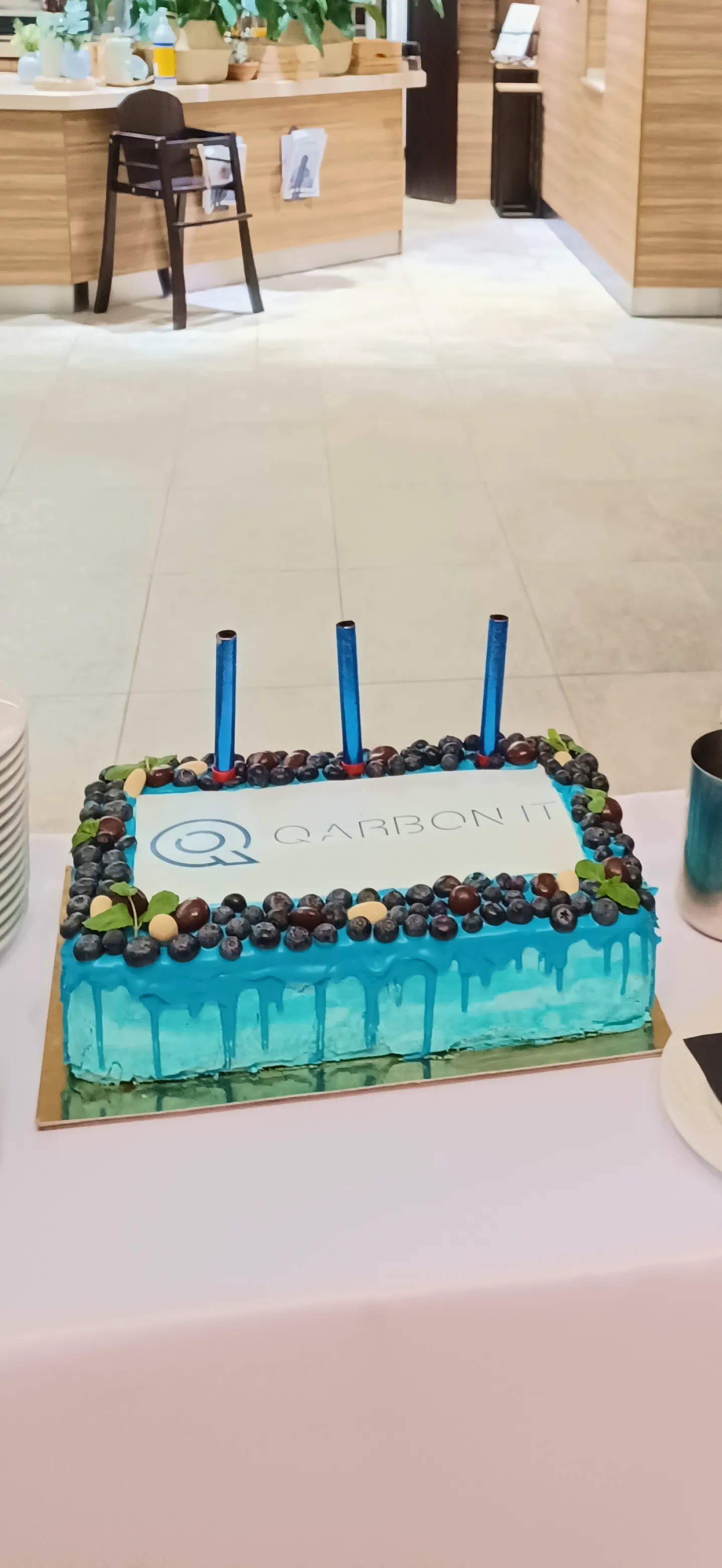 blue cake with three candles