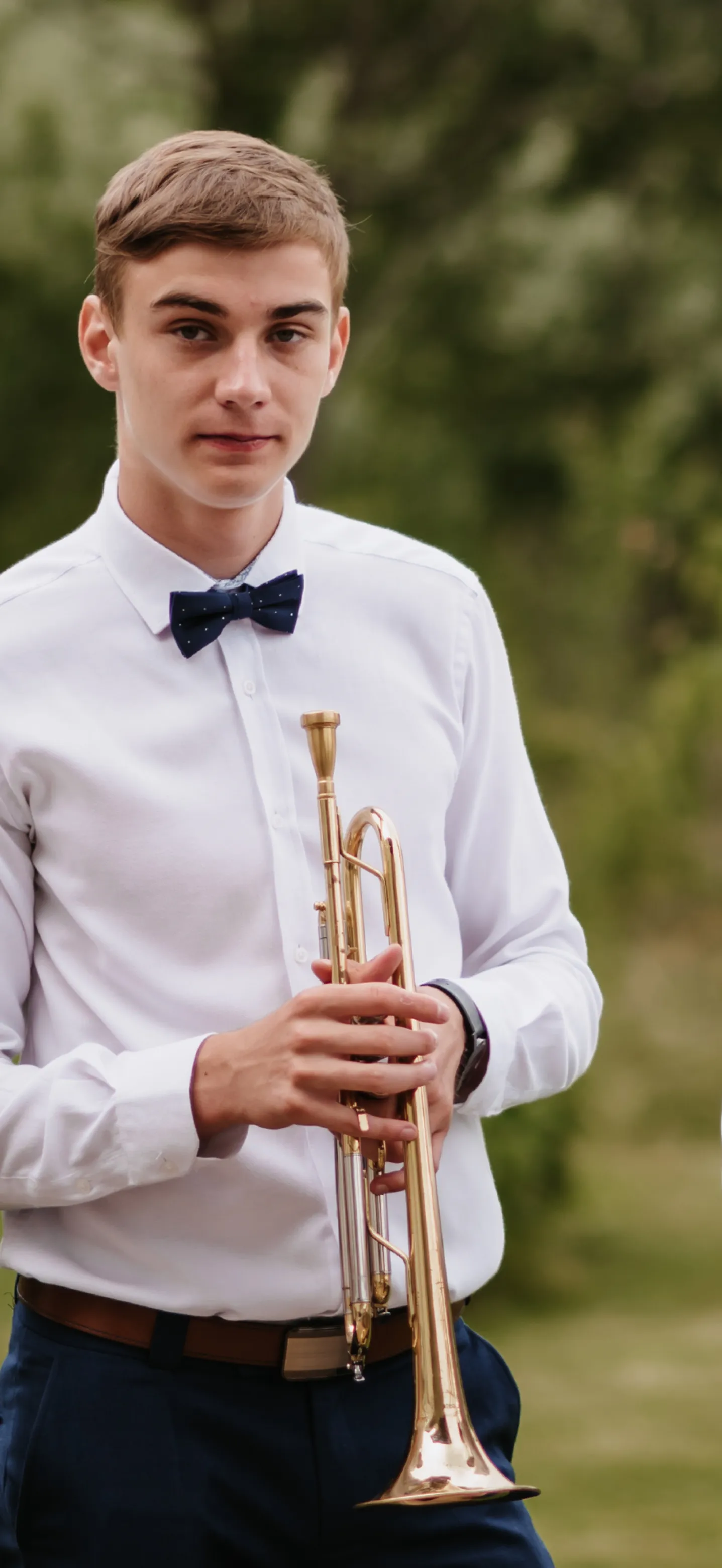 guy dressed in formal wear with a trumpet