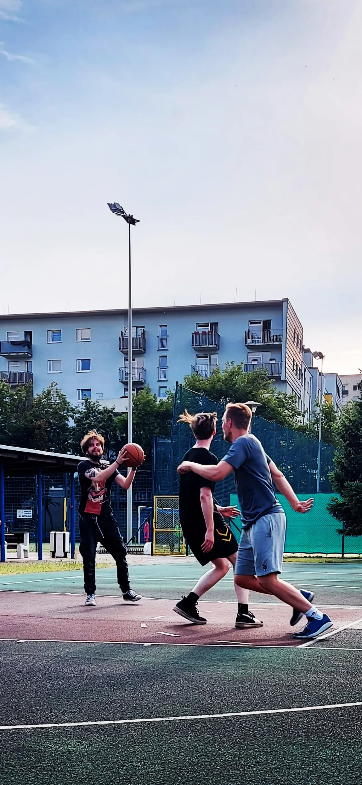 a group playing basketball outside