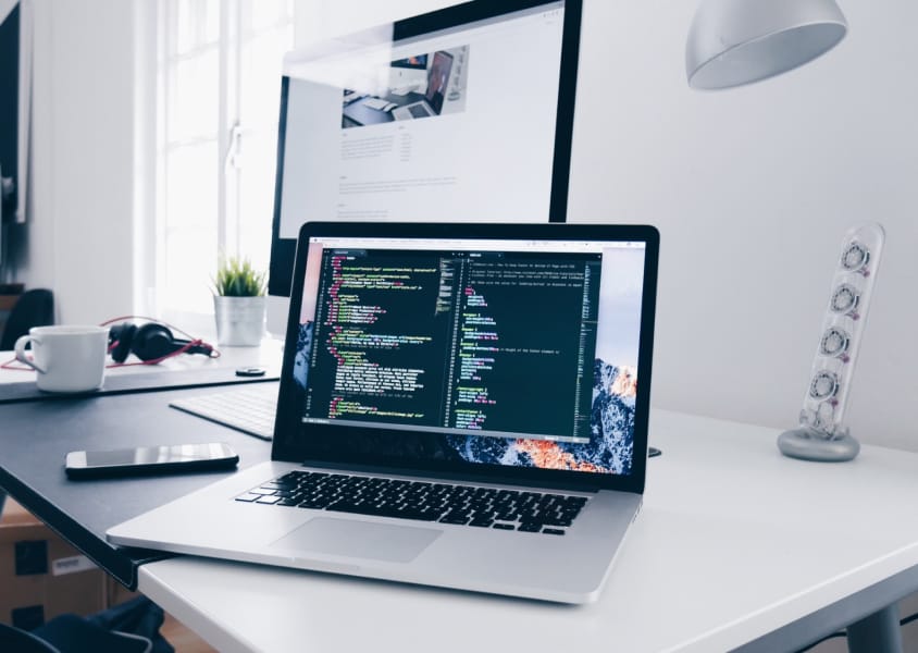 laptop with code on the table